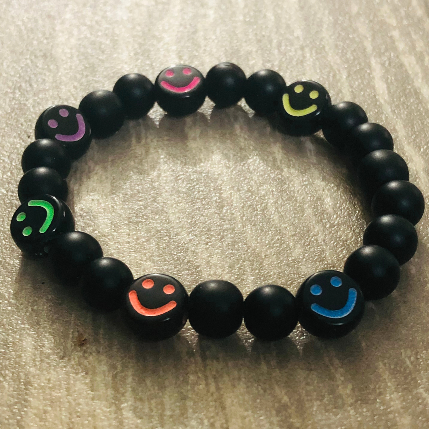 Smiley face bracelet handmade with black beads and elastic cord