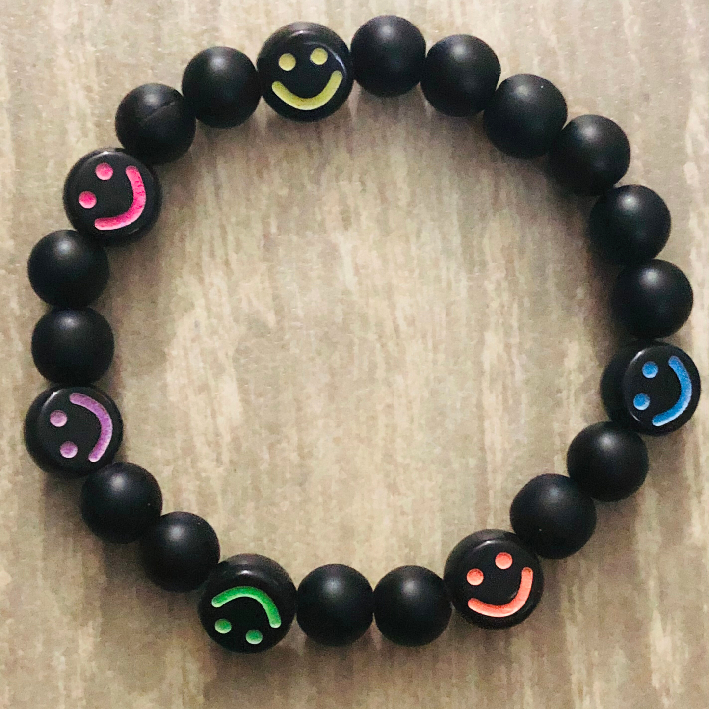 Smiley face bracelet handmade with black beads and elastic cord