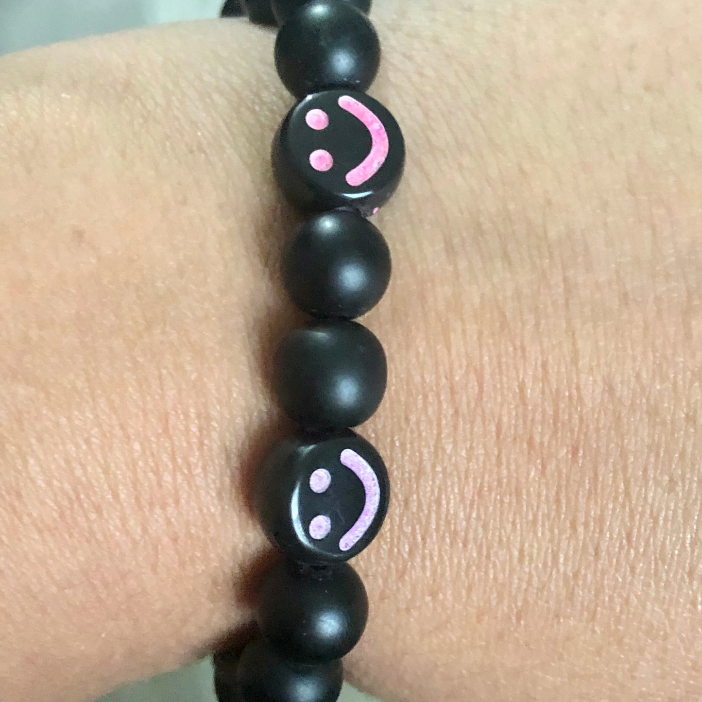 Smiley face bracelet handmade with black beads and elastic cord