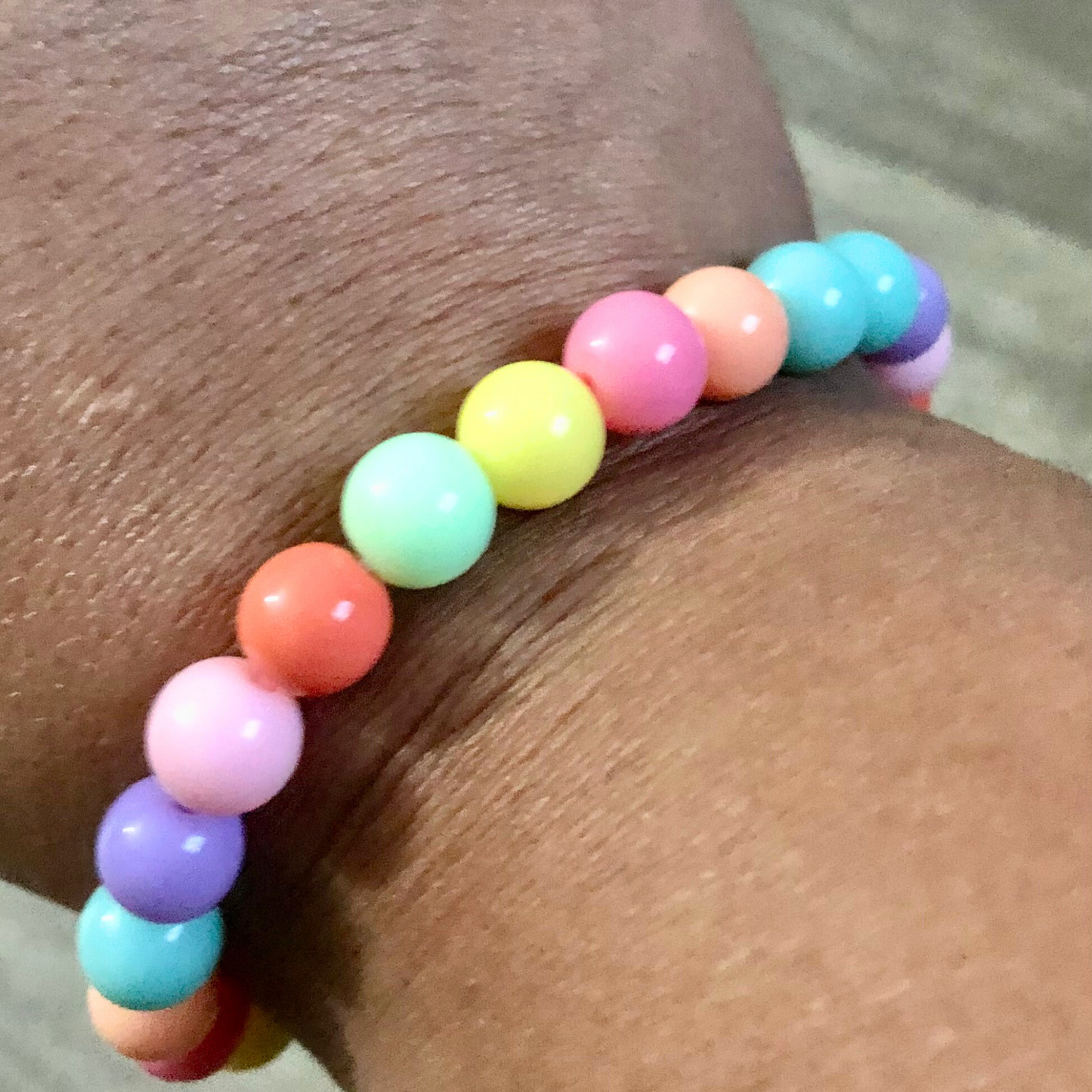 Handmade beaded bracelets with elastic cord and pastel beads