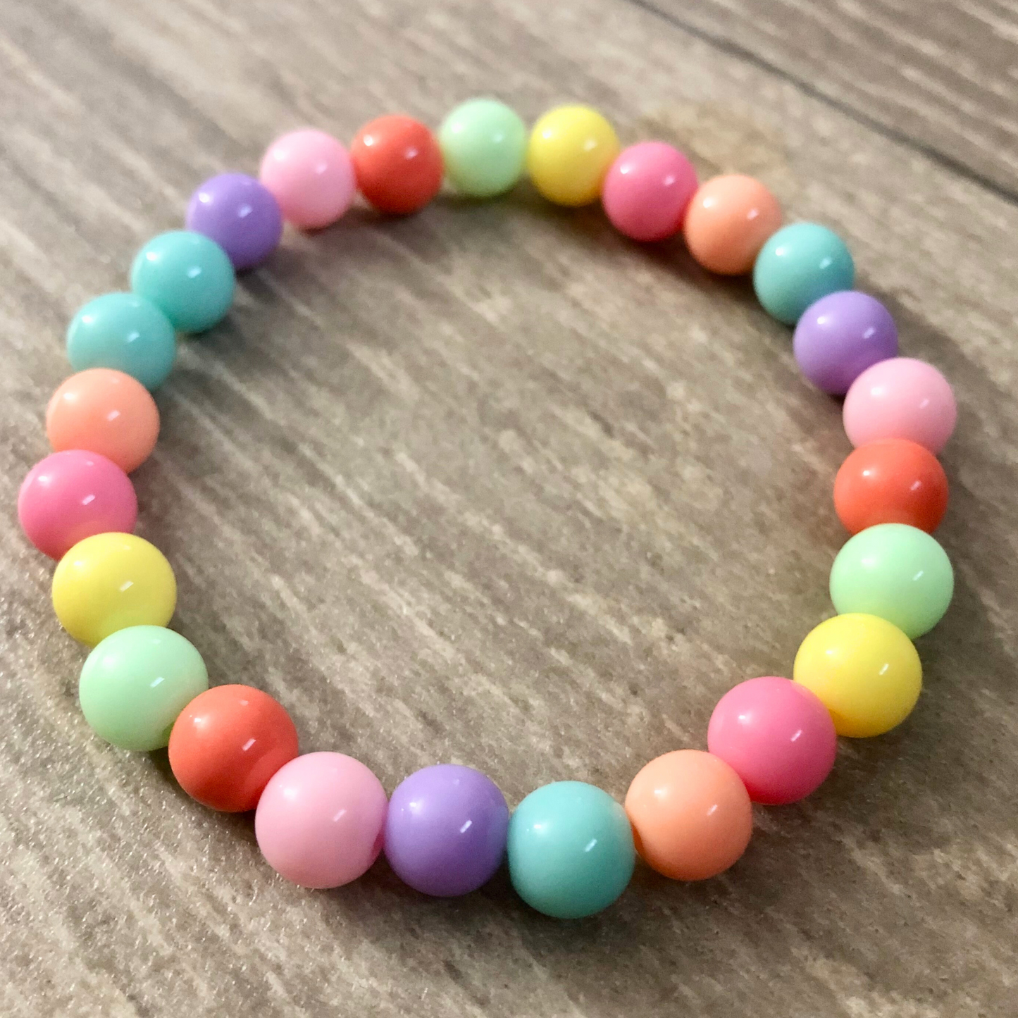 Handmade beaded bracelets with elastic cord and pastel beads