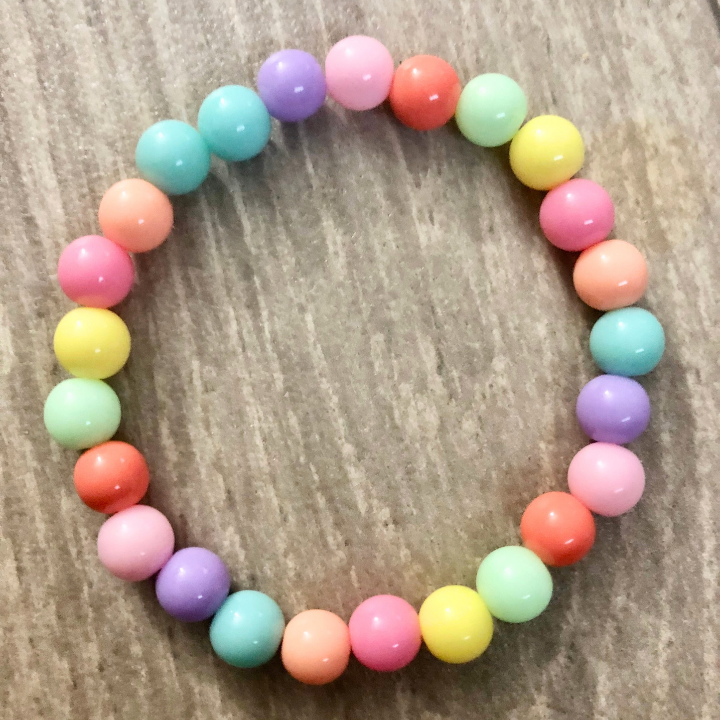 Handmade beaded bracelets with elastic cord and pastel beads