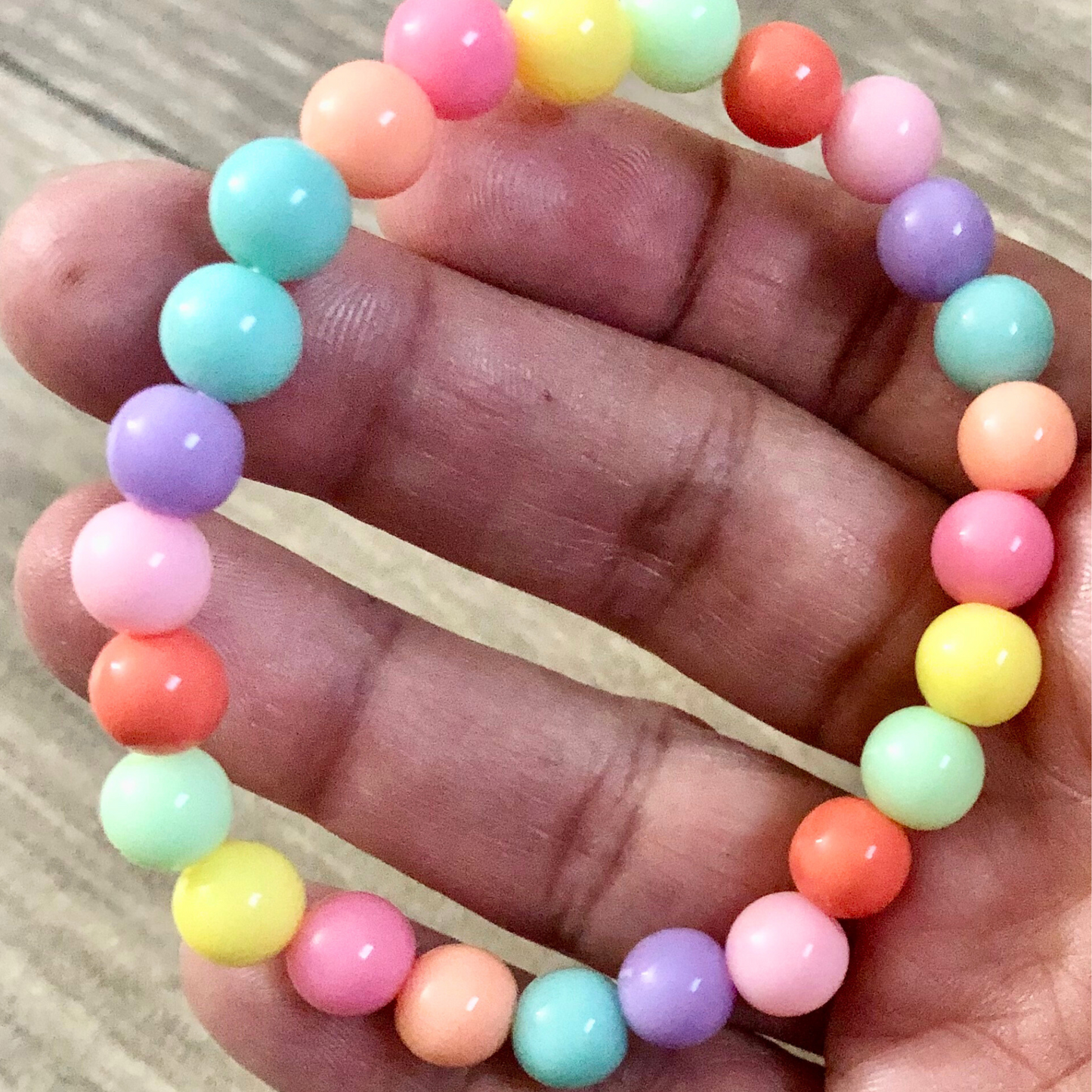 Handmade beaded bracelets with elastic cord and pastel beads