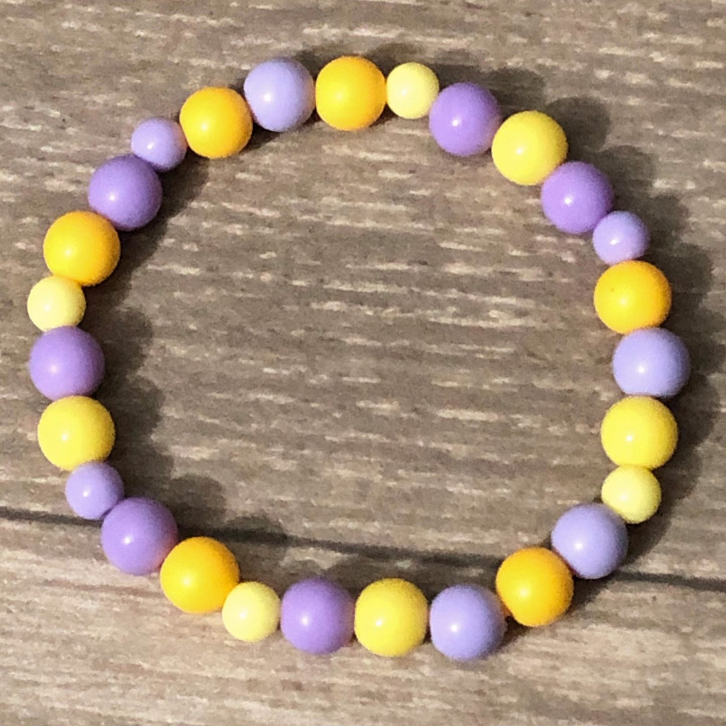 Purple and yellow beaded stretch bracelet available now