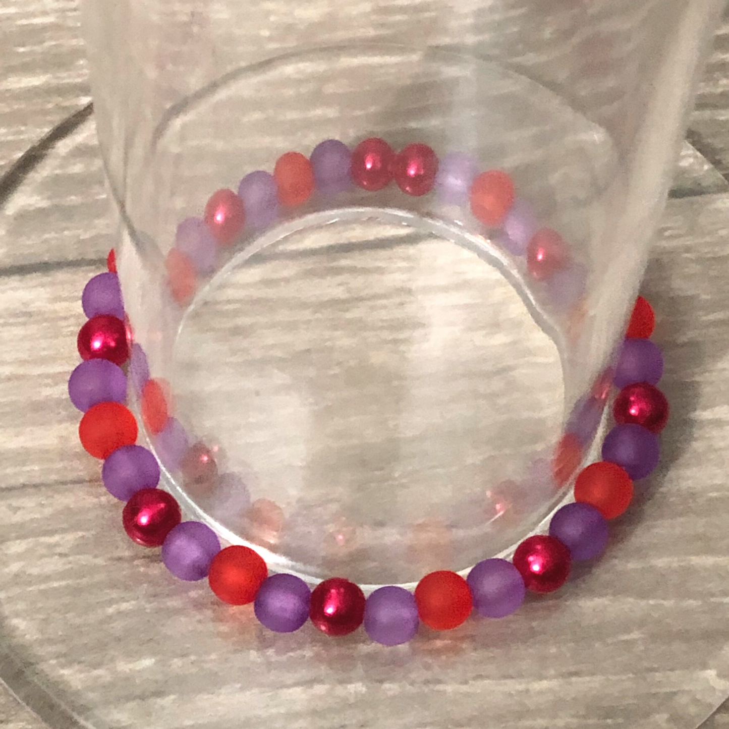 Handmade beaded bracelet with red and purple beads