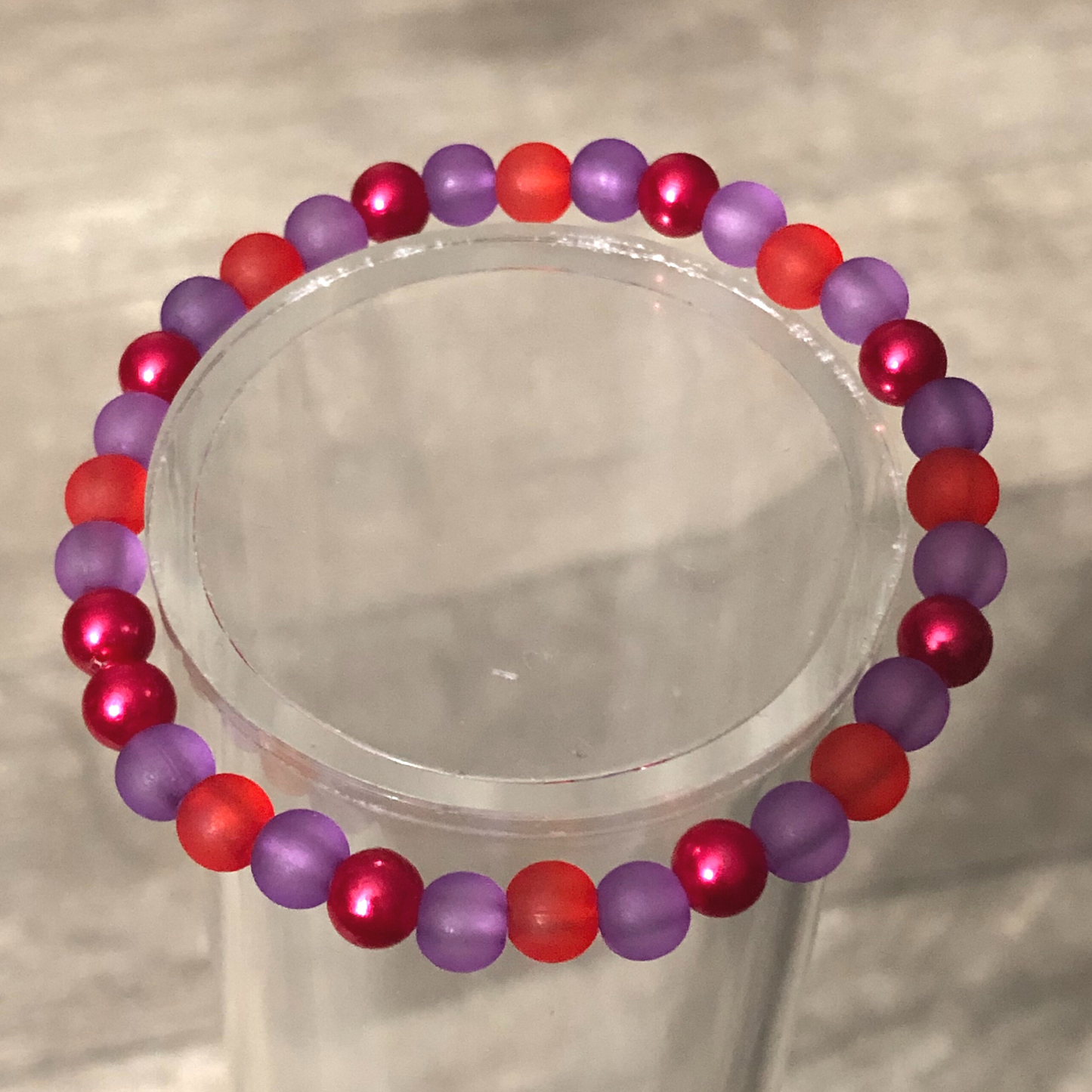 Handmade beaded bracelet with red and purple beads